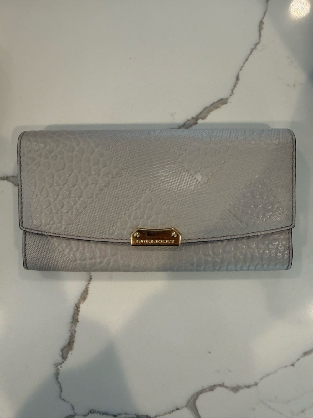 Burberry Light Gray Embossed Nova Leather Continental Wallet with Gold Hardware.